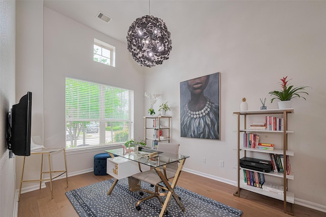 12205 Renewal Way, Houston, TX 77047 - office area featuring wood finished floors, baseboards, and a towering ceiling