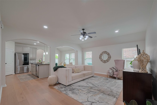 12205 Renewal Way, Houston, TX 77047 - living area featuring arched walkways, a ceiling fan, light wood-style flooring, and recessed lighting