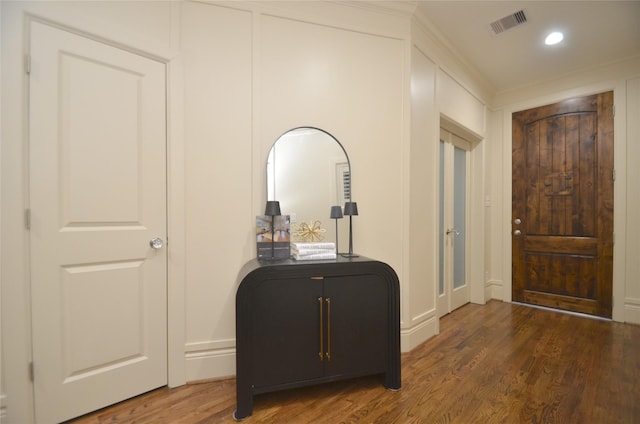 foyer entrance featuring wood finished floors, visible vents, and recessed lighting