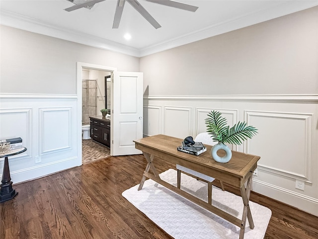office space with crown molding, a ceiling fan, a decorative wall, and wainscoting