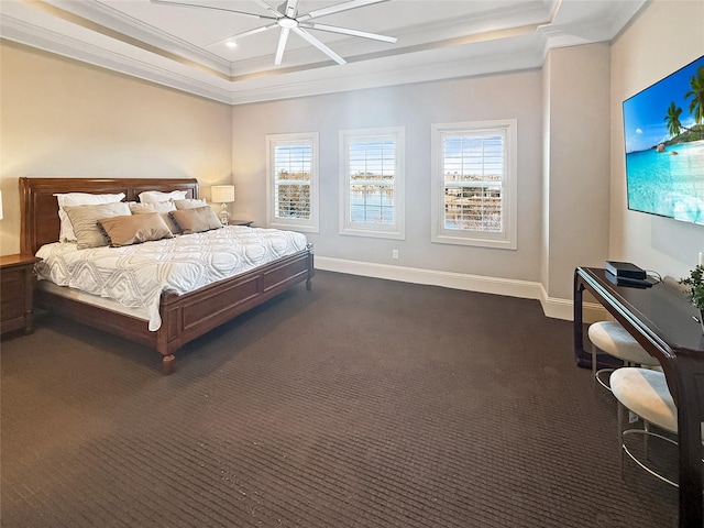 bedroom featuring dark colored carpet, baseboards, a ceiling fan, crown molding, and a raised ceiling