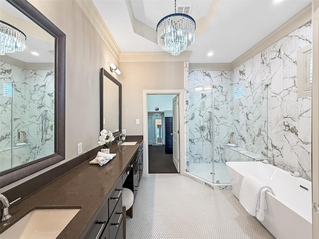 bathroom featuring crown molding, a sink, a marble finish shower, an inviting chandelier, and a freestanding bath