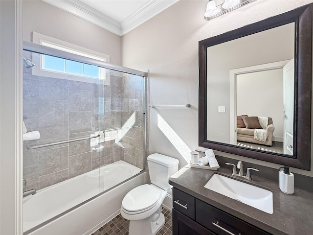 bathroom featuring vanity, toilet, bath / shower combo with glass door, and ornamental molding