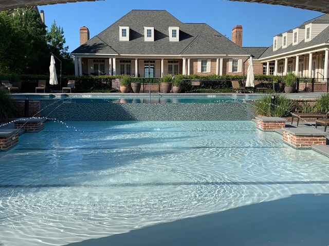 community pool with a hot tub