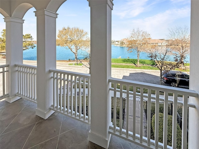 balcony featuring a water view and covered porch