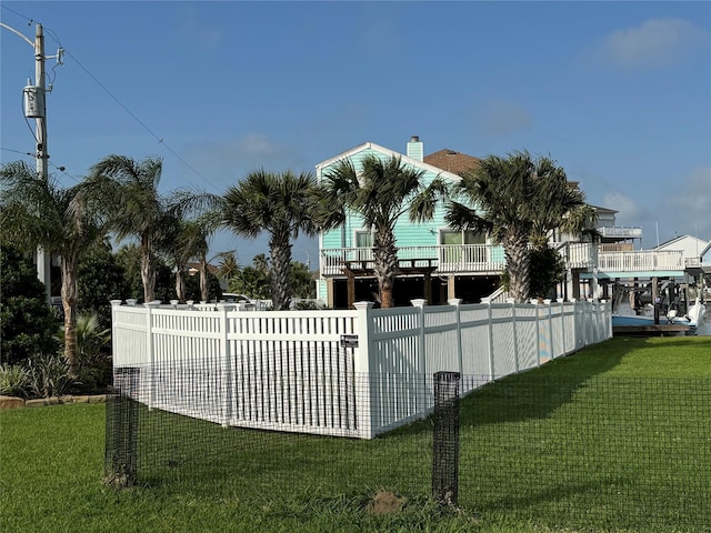 view of pool featuring a lawn and fence