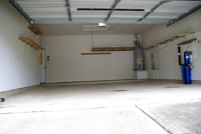 garage with water heater and a garage door opener