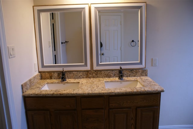 full bathroom featuring double vanity and a sink