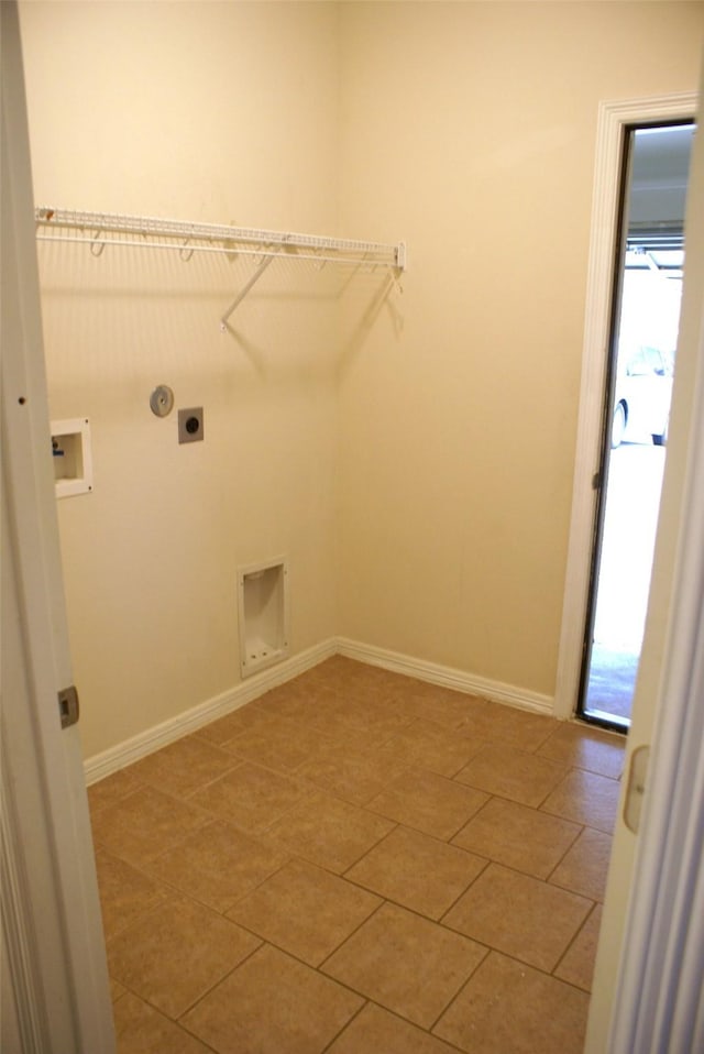 laundry room featuring hookup for a washing machine, laundry area, electric dryer hookup, light tile patterned floors, and baseboards