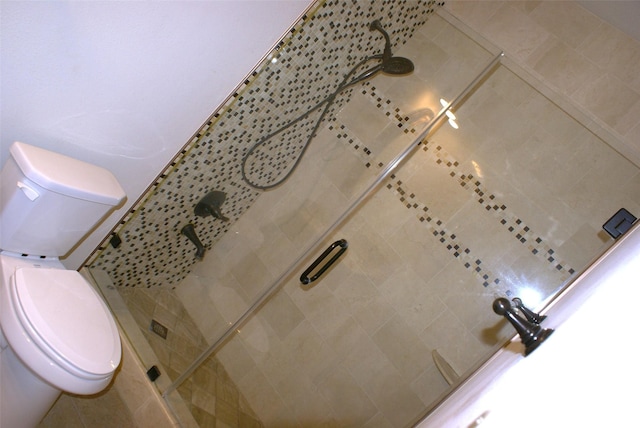 full bath featuring toilet and a stall shower