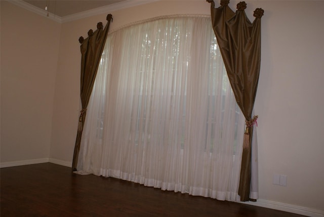 details with ornamental molding, wood finished floors, and baseboards