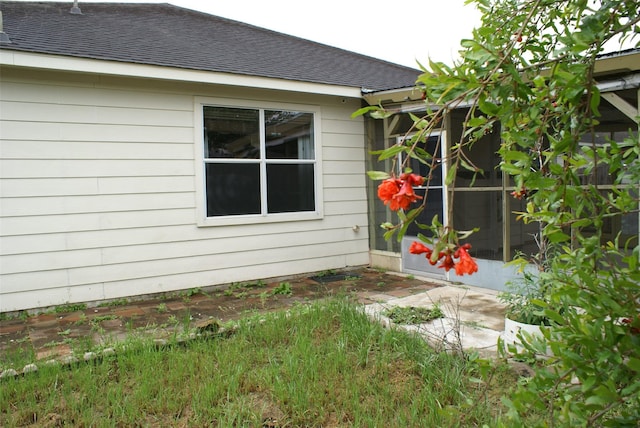 view of property exterior featuring a shingled roof