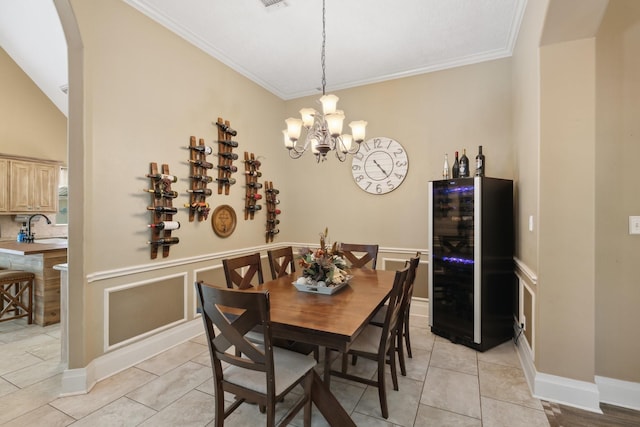 dining area with a chandelier, ornamental molding, light tile patterned flooring, and arched walkways