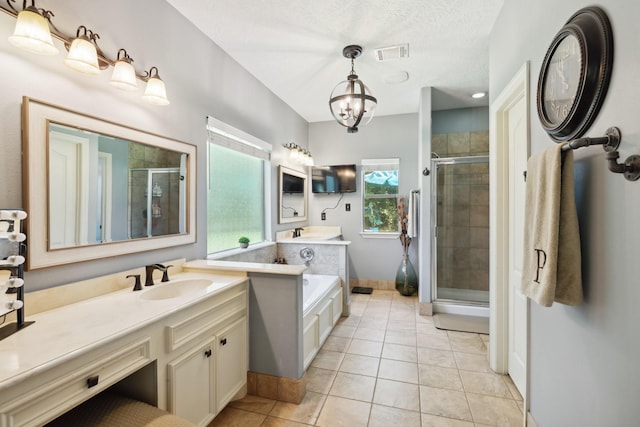 full bathroom featuring tile patterned floors, visible vents, a stall shower, and a sink