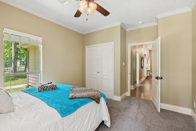 bedroom featuring a ceiling fan, visible vents, baseboards, ornamental molding, and carpet floors