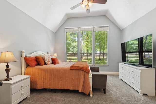 carpeted bedroom featuring lofted ceiling, ceiling fan, and multiple windows