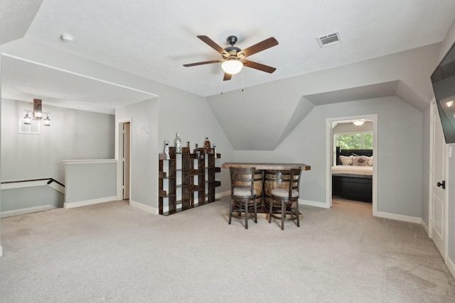 interior space with carpet flooring, visible vents, baseboards, a dry bar, and ceiling fan with notable chandelier