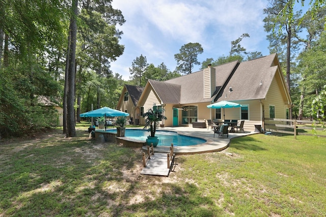 pool featuring fence, a yard, and a patio area