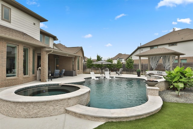 view of pool with an in ground hot tub, a gazebo, a fenced in pool, a fenced backyard, and a patio