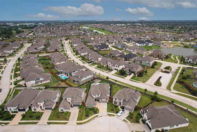drone / aerial view featuring a water view and a residential view