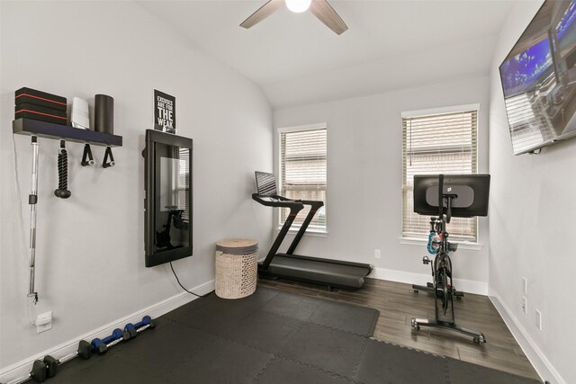 exercise area with vaulted ceiling, baseboards, a ceiling fan, and wood finished floors