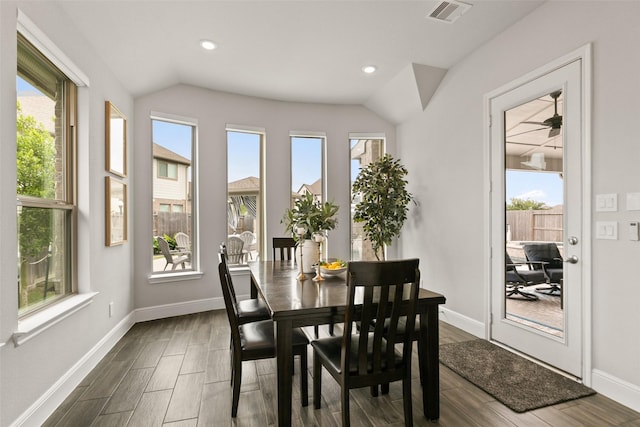 dining room featuring dark wood finished floors, recessed lighting, baseboards, vaulted ceiling, and visible vents