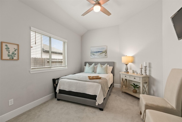 bedroom with a ceiling fan, baseboards, vaulted ceiling, and light carpet