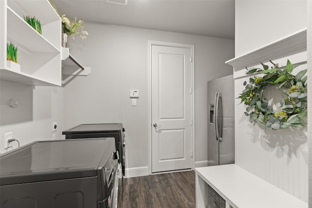 washroom with washer and dryer, dark wood-style flooring, laundry area, and baseboards