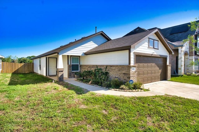 219 Lisa Marie Dr, Angleton, TX 77515 - view of front of house featuring driveway, fence, brick siding, a garage, and a front yard