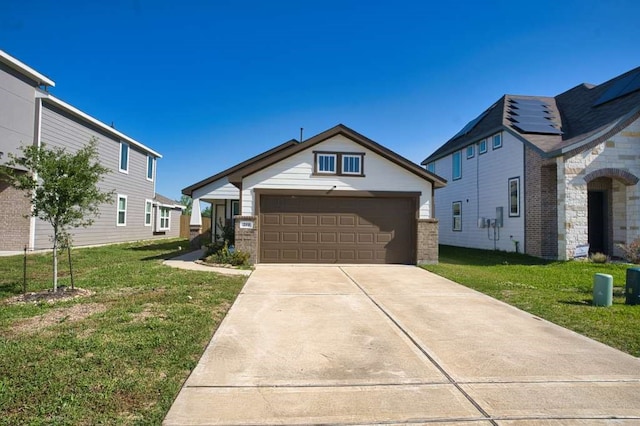 219 Lisa Marie Dr, Angleton, TX 77515 - view of front of home featuring driveway, a front lawn, brick siding, and a garage