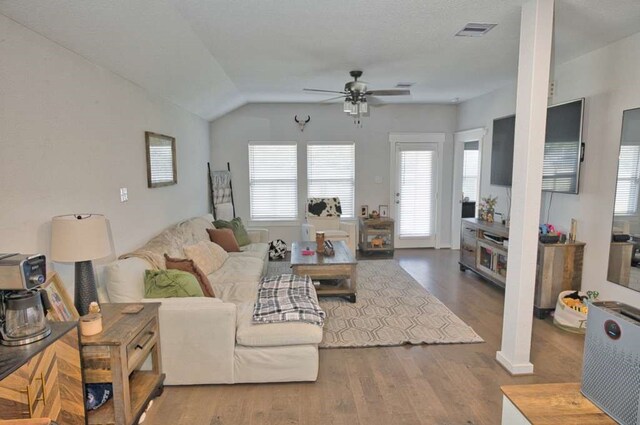 219 Lisa Marie Dr, Angleton, TX 77515 - living room featuring vaulted ceiling, a ceiling fan, wood finished floors, and visible vents