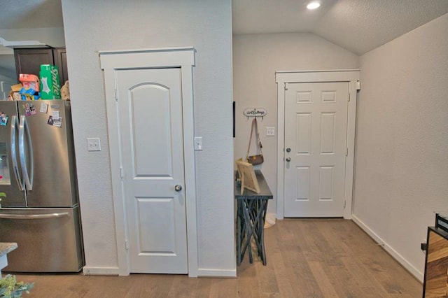 219 Lisa Marie Dr, Angleton, TX 77515 - entryway featuring baseboards, vaulted ceiling, and wood finished floors
