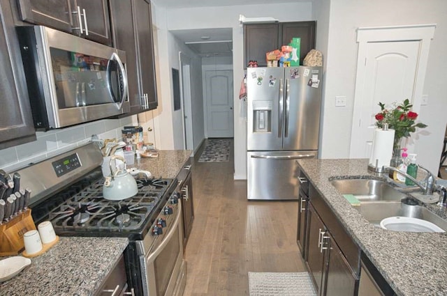 219 Lisa Marie Dr, Angleton, TX 77515 - kitchen with dark wood finished floors, dark brown cabinets, appliances with stainless steel finishes, and a sink