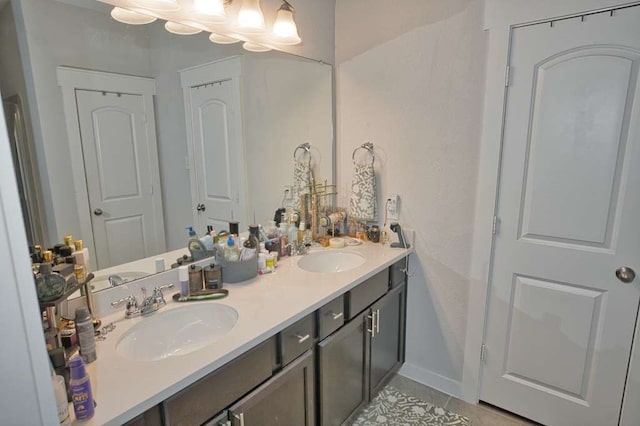 219 Lisa Marie Dr, Angleton, TX 77515 - bathroom featuring tile patterned floors, baseboards, a sink, and double vanity