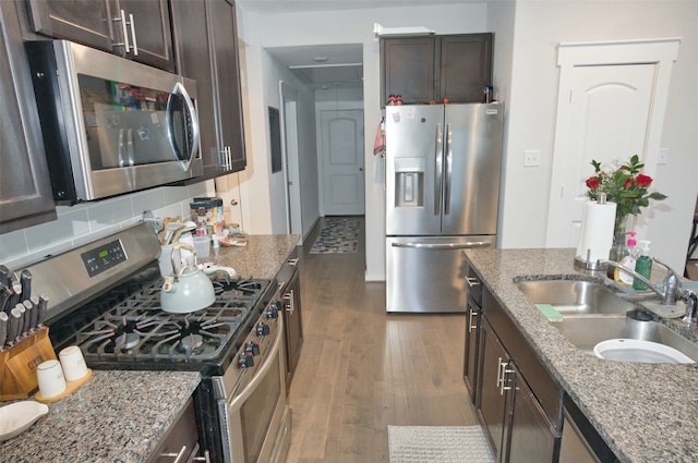 219 Lisa Marie Dr, Angleton, TX 77515 - kitchen with a sink, dark wood-style flooring, stone counters, dark brown cabinetry, and appliances with stainless steel finishes