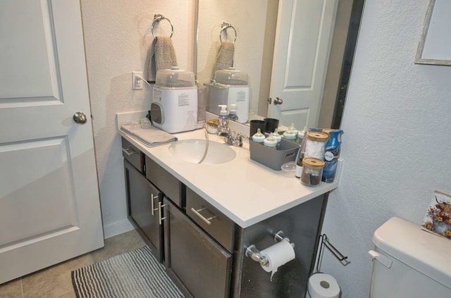 219 Lisa Marie Dr, Angleton, TX 77515 - bathroom with a textured wall, vanity, tile patterned floors, and toilet