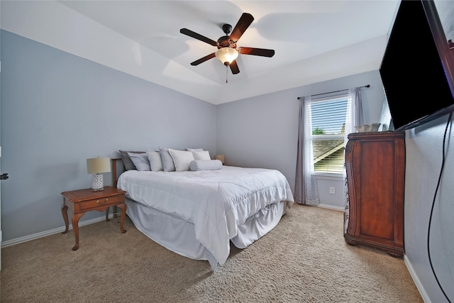 bedroom featuring light colored carpet, baseboards, and ceiling fan