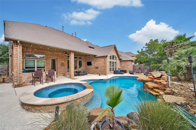 view of pool featuring fence, a patio, and a pool with connected hot tub