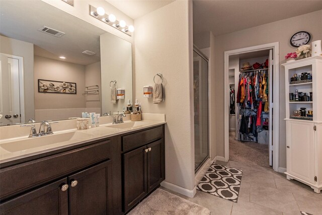2214 Del Mar Dr, Texas City, TX 77568 - bathroom with a spacious closet, a shower stall, visible vents, and a sink