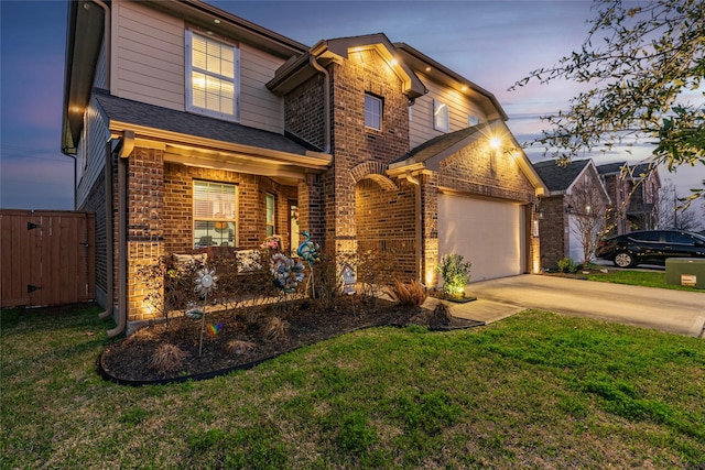 2214 Del Mar Dr, Texas City, TX 77568 - traditional home featuring concrete driveway, an attached garage, brick siding, and a yard