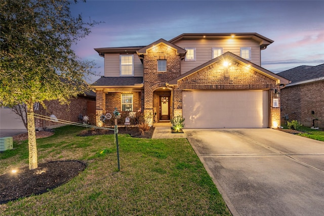 2214 Del Mar Dr, Texas City, TX 77568 - traditional-style house with a lawn, concrete driveway, brick siding, and a garage