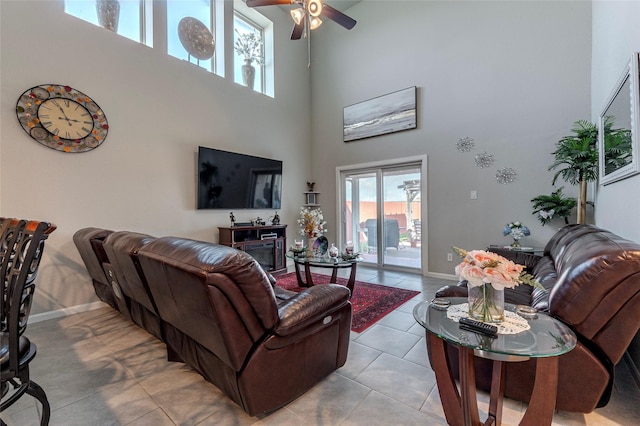 2214 Del Mar Dr, Texas City, TX 77568 - living area featuring ceiling fan, a high ceiling, light tile patterned flooring, and baseboards