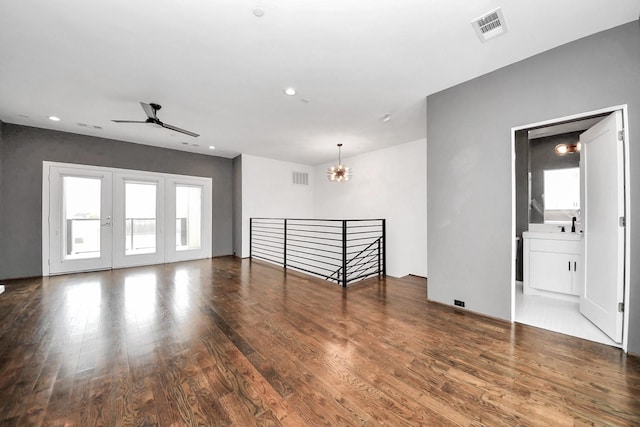 1512 Malone St, Houston, TX 77007 - spare room featuring wood finished floors, visible vents, and ceiling fan with notable chandelier