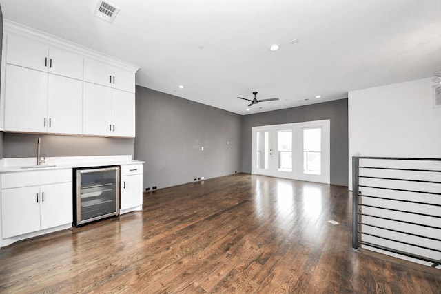 1512 Malone St, Houston, TX 77007 - unfurnished living room featuring a sink, dark wood-style flooring, wine cooler, ceiling fan, and visible vents