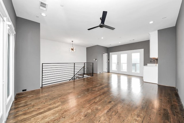 1512 Malone St, Houston, TX 77007 - unfurnished living room featuring a sink, visible vents, recessed lighting, wood finished floors, and ceiling fan with notable chandelier