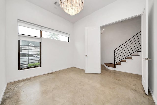 1512 Malone St, Houston, TX 77007 - foyer entrance featuring an inviting chandelier, concrete floors, baseboards, and stairs