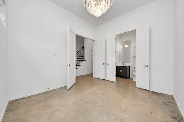 1512 Malone St, Houston, TX 77007 - unfurnished bedroom with a sink, concrete floors, a chandelier, ensuite bathroom, and baseboards