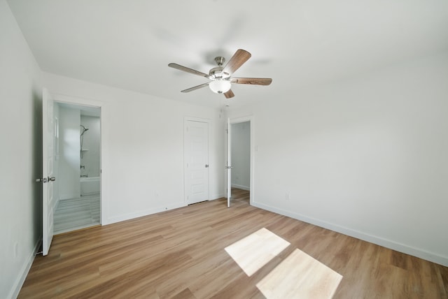 9711 Derrik Dr, Houston, TX 77080 - unfurnished bedroom with ensuite bath, baseboards, a ceiling fan, and light wood-type flooring