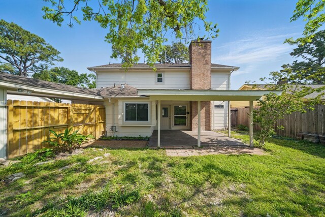 9711 Derrik Dr, Houston, TX 77080 - rear view of house featuring a yard, a patio area, a chimney, and a fenced backyard