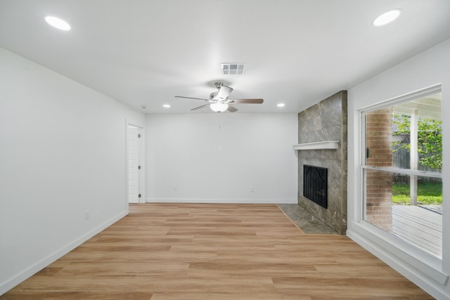 9711 Derrik Dr, Houston, TX 77080 - unfurnished living room with recessed lighting, visible vents, light wood-style flooring, a tiled fireplace, and ceiling fan